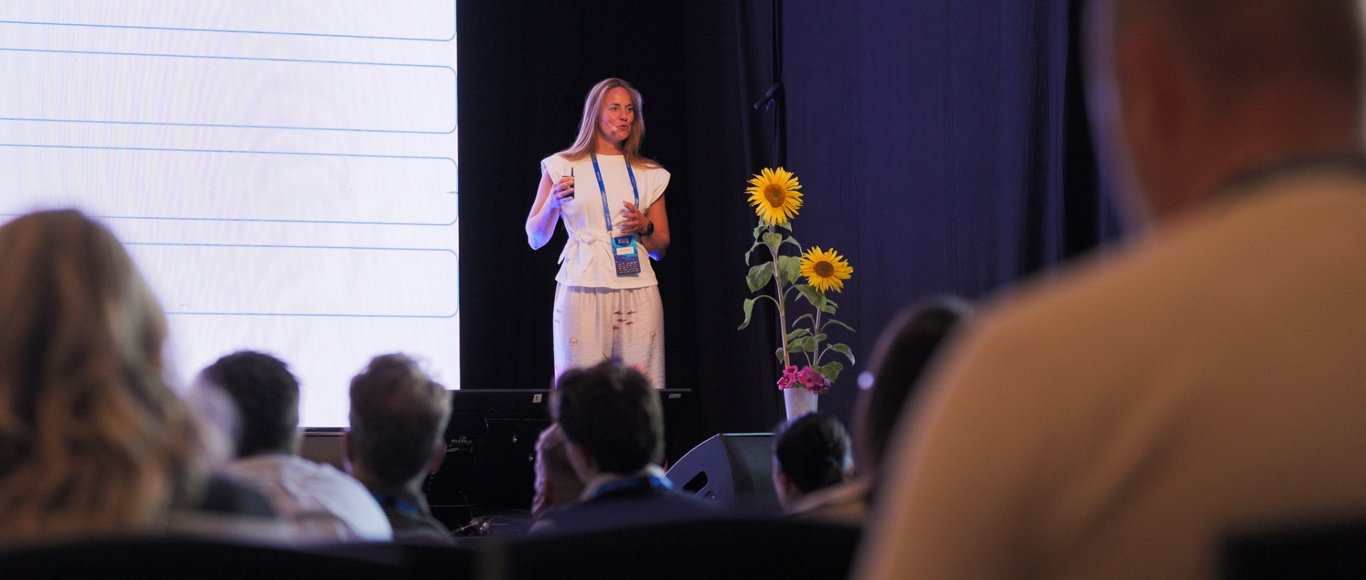 Signe Simonsen speaking on stage at a conference
